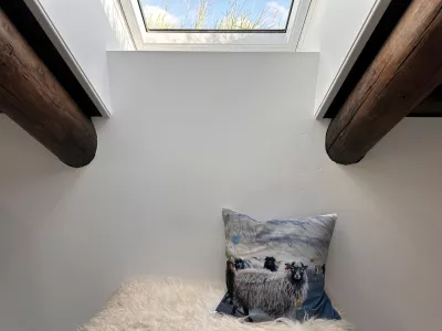 A sheep-printed pillow lies in a guesthouse in Gjogv at the Faroe Islands, Sept. 8, 2025. (AP Photo/Cara Anna)