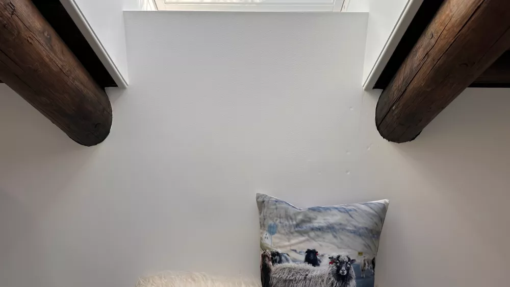 A sheep-printed pillow lies in a guesthouse in Gjogv at the Faroe Islands, Sept. 8, 2025. (AP Photo/Cara Anna)