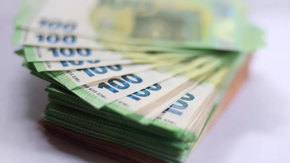 FILED - 03 June 2025, Bavaria, Augsburg: 100 euro banknotes placed on a table. Photo: Karl-Josef Hildenbrand/dpa