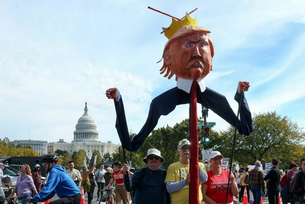 Demonstrators hold an effigy depicting U.S. President Donald Trump during a "No Kings" protest against U.S. President Donald Trump's policies, in Washington, D.C., U.S., October 18, 2025. REUTERS/Kylie Cooper