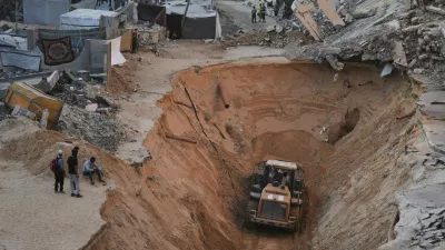 Palestinians watch members of the Hamas militant group searching for bodies of the hostages in Khan Younis, southern Gaza Strip, Saturday, Oct. 18, 2025. (AP Photo/Jehad Alshrafi)