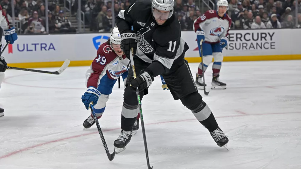 Oct 7, 2025; Los Angeles, California, USA; Los Angeles Kings center Anze Kopitar (11) controls the puck during the second period against the Colorado Avalanche at Crypto.com Arena. Mandatory Credit: Jayne Kamin-Oncea-Imagn Images