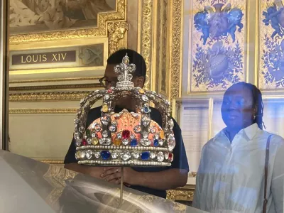 People check jewelry in the Apollo Gallery of the Louvre museum on Sept. 4, 2025 in Paris. (AP Photo/Alexander Turnbull)