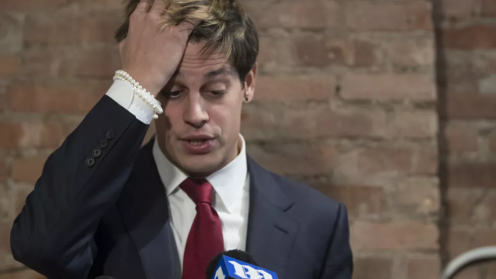 Milo Yiannopoulos speaks during a news conference, Tuesday, Feb. 21, 2017, in New York. Yiannopoulos has resigned as editor of Breitbart Tech after coming under fire from other conservatives over comments on sexual relationships between boys and older men. (AP Photo/Mary Altaffer)
