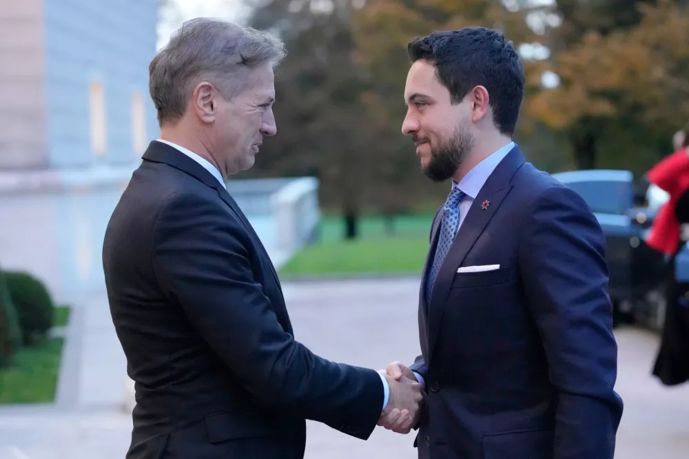 Hussein, Crown Prince of Jordan, right, is welcomed by Slovenian Prime Minister Robert Golob in Brdo, Slovenia, Sunday, Oct. 19, 2025. (AP Photo/Darko Bandic)