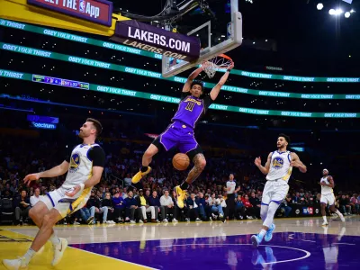 Feb 6, 2025; Los Angeles, California, USA; Los Angeles Lakers center Jaxson Hayes (11) dunks for the basket against Golden State Warriors forward Jackson Rowe (44) and guard Pat Spencer (61) during the first half at Crypto.com Arena. Mandatory Credit: Gary A. Vasquez-Imagn Images