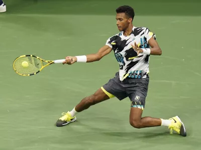 Felix Auger-Aliassime, of Canada, returns a shot to Andy Murray, of Great Britain, during the third round of the U.S. Open tennis championships, Thursday, Sept. 3, 2020, in New York. (AP Photo/Frank Franklin II)