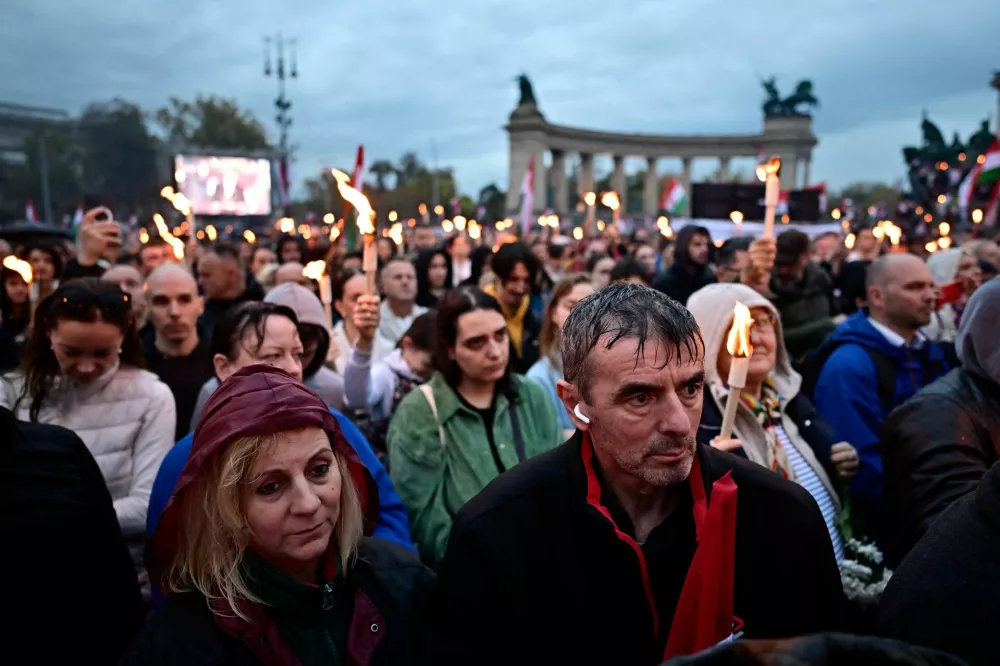 People listen to the speech given by Peter Magyar, leader of the opposition TISZA party, to mark the 69th anniversary of the Hungarian Uprising of 1956, in Budapest, Hungary, October 23, 2025. REUTERS/Marton Monus