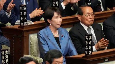 Sanae Takaichi, center, leader of the ruling Liberal Democratic Party, reacts as she was elected as Japan's new prime minister during the extraordinary session of the lower house, in Tokyo, Japan, Tuesday, Oct. 21, 2025.(AP Photo/Eugene Hoshiko)