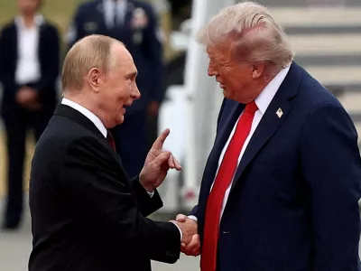 FILE PHOTO: U.S. President Donald Trump shakes hand with Russian President Vladimir Putin, as they meet to negotiate for an end to the war in Ukraine, at Joint Base Elmendorf-Richardson in Anchorage, Alaska, U.S., August 15, 2025. REUTERS/Kevin Lamarque/File Photo