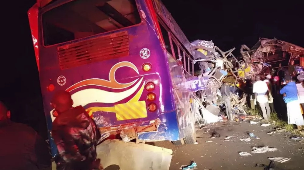 People gather at the scene of a multiple vehicles collision that left at least 63 dead near Gulu, northern Uganda, Wednesday, Oct. 22, 2025. (AP Photo/Uganda Red Cross)