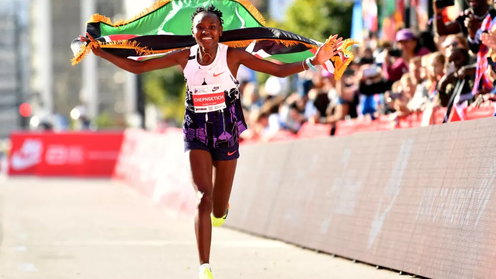 FILE PHOTO: Oct 13, 2024; Chicago, IL, USA; Ruth Chepngetich of Kenya celebrates after finishing first in the women's race, setting a world record at 2:09:56 during the Chicago Marathon at Grant Park. Mandatory Credit: Patrick Gorski-Imagn Images   TPX IMAGES OF THE DAY/File Photo
