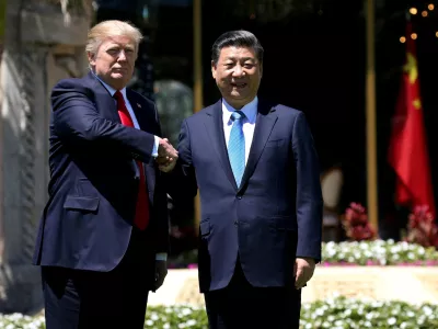 FILE PHOTO: U.S. President Donald Trump (L) and China's President Xi Jinping shake hands while walking at Mar-a-Lago estate after a bilateral meeting in Palm Beach, Florida, U.S., April 7, 2017. REUTERS/Carlos Barria/File Photo