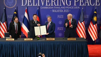 Malaysia's Prime Minister Anwar Ibrahim, left, and U.S. President Donald Trump, right, watch as Thailand's Prime Minister Anutin Charnvirakul, second left, and Cambodia's Prime Minister Hun Manet hold up a document after the ceremonial signing of a ceasefire agreement between Thailand and Cambodia on the sidelines of the 47th Association of Southeast Asian Nations (ASEAN) summit in Kuala Lumpur, Malaysia, Sunday, Oct. 26, 2025. (Mohd Rasfan/Pool Photo via AP)