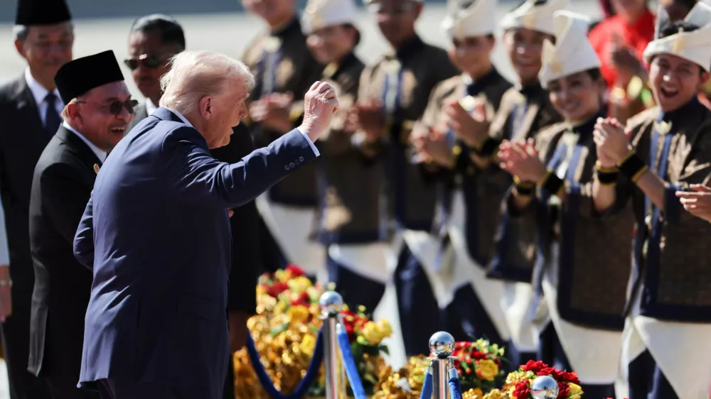 U.S. President Donald Trump reacts to dancing performers during a welcoming ceremony after arriving at Kuala Lumpur International Airport, to attend the 47th Association of Southeast Asian Nations (ASEAN) summit in Kuala Lumpur, Malaysia, Sunday, Oct. 26, 2025. (Hasnoor Hussain/Pool Photo via AP)