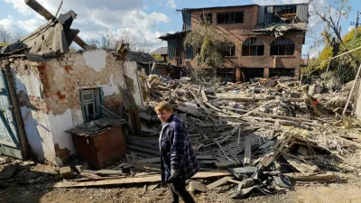 Oksana Lavrenteva, 52, walks past rubble of her house following what Russian-installed authorities described as an overnight Ukrainian missile strike, amid the Russia-Ukraine military conflict in Yasynuvata (Yasinovataya) in the Donetsk region, a Russian-controlled area of Ukraine, October 26, 2025. REUTERS/Alexander Ermochenko