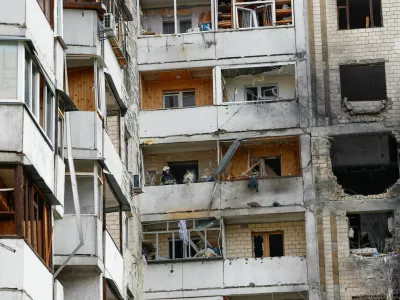 Rescuers work inside an apartment building damaged during an overnight Russian drone strike, amid Russia's attack on Ukraine, in Kyiv, Ukraine October 26, 2025. REUTERS/Valentyn Ogirenko