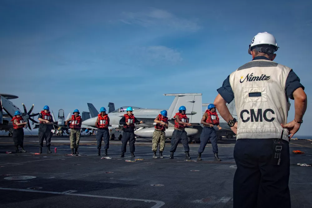 U.S. Navy sailors conduct a line handling evolution on the flight deck of the aircraft carrier USS Nimitz during a replenishment-at-sea in the South China Sea, June 14, 2025. U.S. Navy/Mass Communication Specialist Seaman Matthew C. Wolf/Handout via REUTERS. THIS IMAGE HAS BEEN SUPPLIED BY A THIRD PARTY