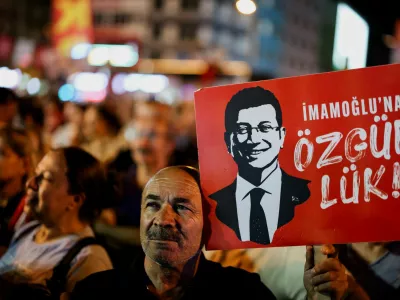 FILE PHOTO: A man holds up a sign featuring an image of Istanbul Mayor Ekrem Imamoglu during a rally to protest against a recent court ruling that ousted the main opposition Republican People's Party's (CHP) Istanbul provincial leadership, in Istanbul, Turkey, September 10, 2025. REUTERS/Umit Bektas/File Photo