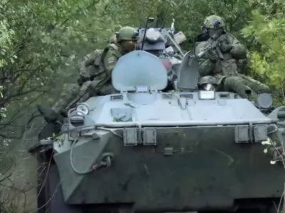 In this photo taken from video released by Russian Defense Ministry Press Service on Monday, Sept. 29, 2025, Russian soldiers ride an APC on an undisclosed location in Ukraine. (Russian Defense Ministry Press Service via AP)