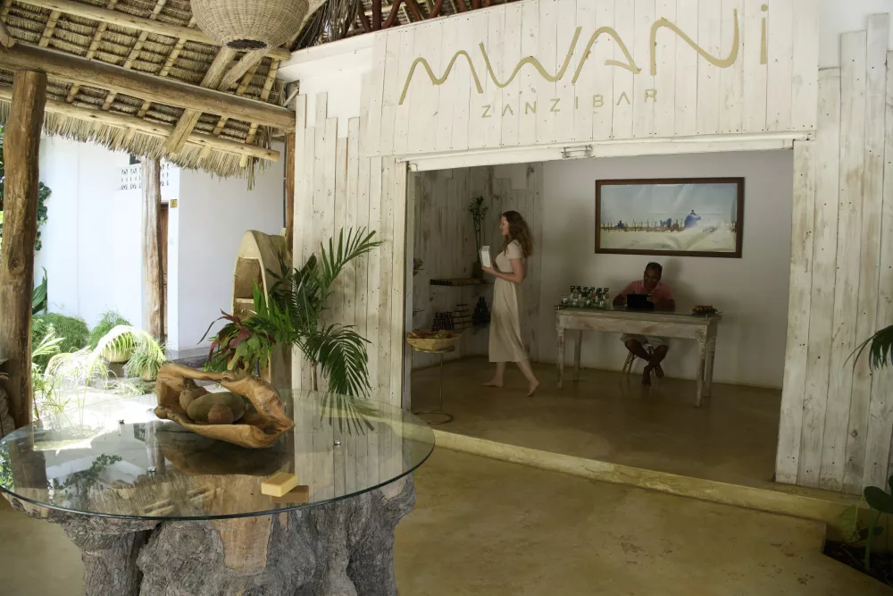 Klara Schade, left, the director of Mwani Zanzibar, a boutique seaweed farm and factory, walks around in the shop in Paje, Zanzibar, Tanzania, Thursday, July 24, 2025. (AP Photo/Jack Denton)