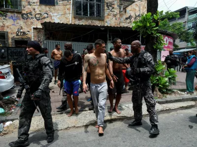 Members of the military police special unit detain suspected drug dealers during a police operation against drug trafficking at the favela do Penha, in Rio de Janeiro, Brazil October 28, 2025. REUTERS/Aline Massuca