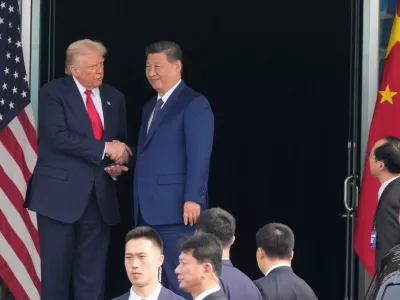 President Donald Trump, left, and Chinese President Xi Jinping, right, shake hands after their U.S.-China summit meeting at Gimhae International Airport Jinping in Busan, South Korea, Thursday, Oct. 30, 2025. (AP Photo/Mark Schiefelbein)