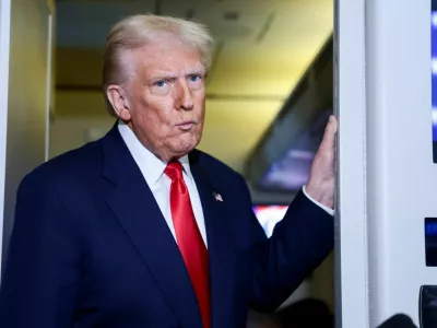 U.S. President Donald Trump reacts while speaking to members of the media on board Air Force One en route to the U.S., October 30, 2025. REUTERS/Evelyn Hockstein