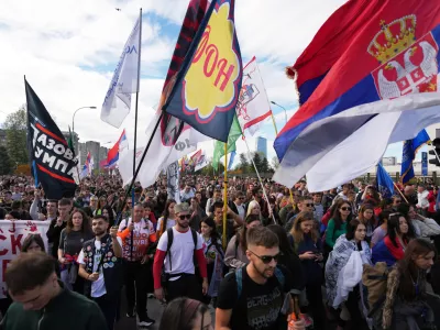 People gather, among them students, to walk on the street towards the northern city of Novi Sad, for a huge rally on Nov. 1 marking the first anniversary of a train station disaster that killed 16 people, in Belgrade, Serbia, Thursday, Oct. 30, 2025. (AP Photo/Darko Vojinovic)