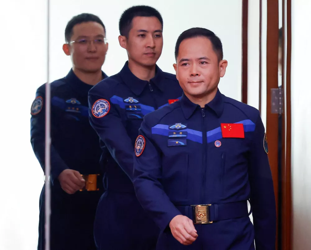 Astronauts Zhang Lu, Wu Fei, and Zhang Hongzhang arrive at a press conference before the Shenzhou-21&nbsp;spaceflight mission to&nbsp;China's Tiangong&nbsp;space&nbsp;station, at&nbsp;Jiuquan&nbsp;Satellite&nbsp;Launch&nbsp;Center, near&nbsp;Jiuquan, Gansu province,&nbsp;China, October 30, 2025. REUTERS/Maxim Shemetov