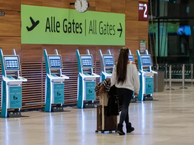 31 October 2025, Brandenburg, Schoenefeld: A passenger walks inside a building at BER airport. The capital's BER airport was closed for around two hours this evening due to the sighting of a drone. A spokesperson for the airport told dpa. According to the statement, flight operations were suspended between 8.08 pm and 9.58 pm. A number of flights were diverted. Photo: Carsten Koall/dpa