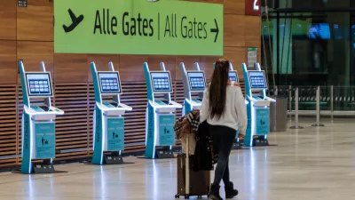 31 October 2025, Brandenburg, Schoenefeld: A passenger walks inside a building at BER airport. The capital's BER airport was closed for around two hours this evening due to the sighting of a drone. A spokesperson for the airport told dpa. According to the statement, flight operations were suspended between 8.08 pm and 9.58 pm. A number of flights were diverted. Photo: Carsten Koall/dpa