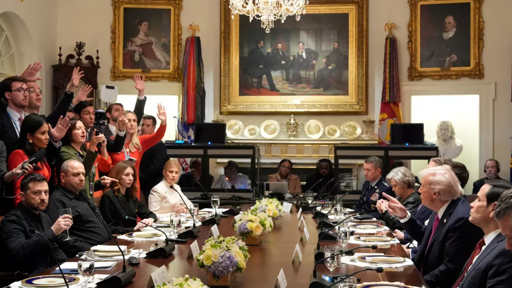 President Donald Trump, second right, and Ukraine's President Volodymyr Zelenskyy, seated left, sit as reporters ask questions before a lunch in the Cabinet Room of the White House, Friday, Oct. 17, 2025, in Washington. (AP Photo/Alex Brandon)