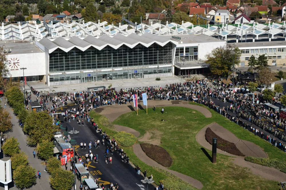 People gather outside the train station on the first anniversary of the disaster that killed 16 people, in Novi Sad, Serbia, Saturday, Nov. 1, 2025. (AP Photo/Darko Vojinovic)