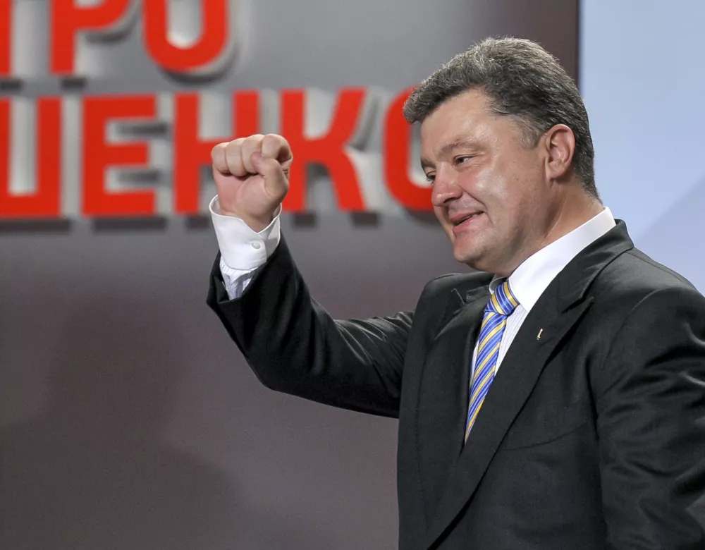 Ukrainian presidential candidate Petro Poroshenko reacts during his press conference in Kiev, Ukraine, Sunday, May 25, 2014. An exit poll showed that billionaire candy-maker Petro Poroshenko won Ukraine's presidential election outright Sunday in the first round &mdash; a vote that authorities hoped would unify the fractured nation. (AP Photo/Mykola Lazarenko, Pool)