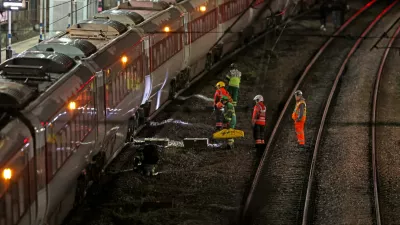 Emergency personnel inspect a train at the Huntingdon, England, train station in Cambridgeshire after people were stabbed Saturday, Nov. 1, 2025. (Chris Radburn/PA via AP)