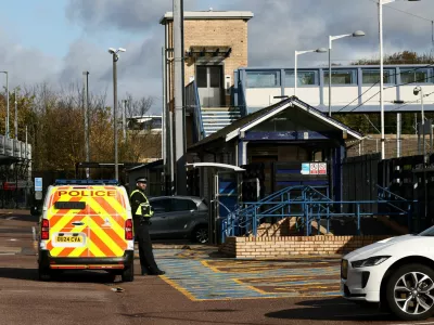 A police officer stands next to a police vehicle at Huntingdon Station, following a series of stabbings on a London North Eastern Railway (LNER) train, near Cambridge, Britain, November 2, 2025. REUTERS/Jack Taylor
