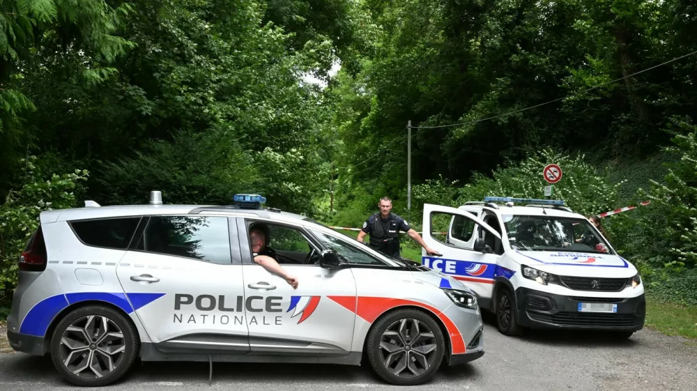Police France, francija, policija, french police, francoska policijaPolice cars are parked in front of a cordoned-off area, near a sports field where a 32-year-old man was found dead with his throat slit and gutted, in Pont-de-Metz on August 4, 2025. The victim had stab wounds to the neck and back and has been found by a walker in a cross position, police told AFP.,Image: 1027676326, License: Rights-managed, Restrictions:, Model Release: no