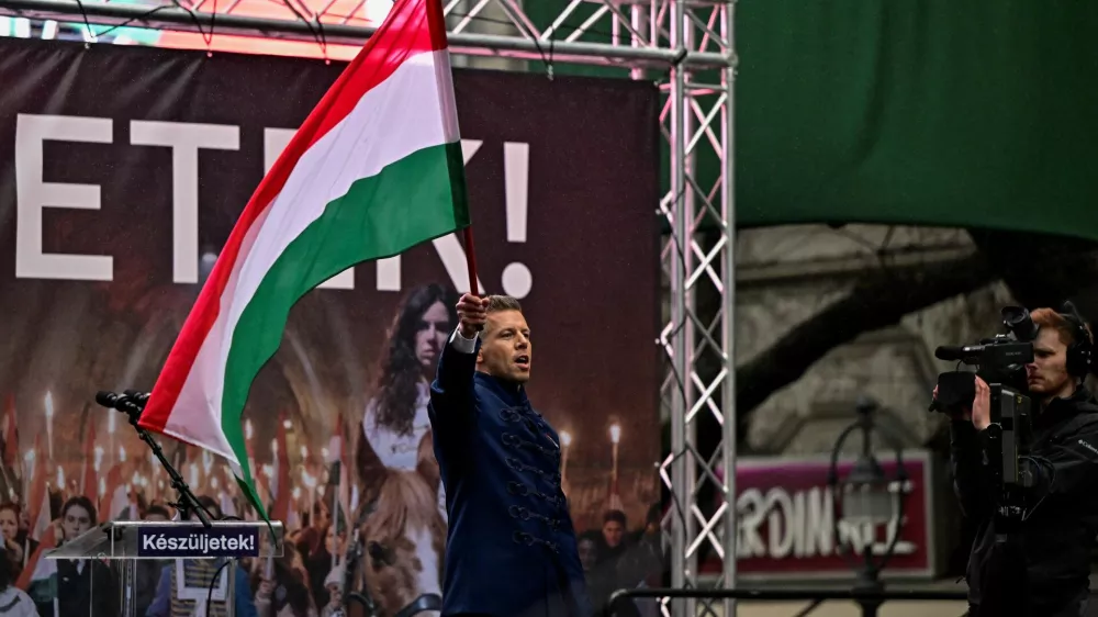 Peter Magyar, leader of Hungarian opposition TISZA party, waves a national flag at the demonstration, during Hungary's National Day celebrations, which also commemorate the 1848 Hungarian Revolution against the Habsburg monarchy, in Budapest, Hungary, March 15, 2025. REUTERS/Marton Monus