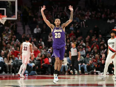 Los Angeles Lakers guard Nick Smith Jr. (20) reacts after a basket against the Portland Trail Blazers during the second half of an NBA basketball game Monday, Nov. 3, 2025, in Portland, Ore. (AP Photo/Amanda Loman)