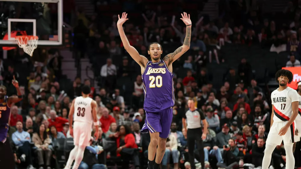 Los Angeles Lakers guard Nick Smith Jr. (20) reacts after a basket against the Portland Trail Blazers during the second half of an NBA basketball game Monday, Nov. 3, 2025, in Portland, Ore. (AP Photo/Amanda Loman)