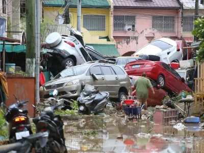 Vehicles lie piled on after flooding caused by Typhoon Kalmaegi in Cebu city, central Philippines, Tuesday, Nov. 4, 2025. (AP Photo/Jacqueline Hernandez)