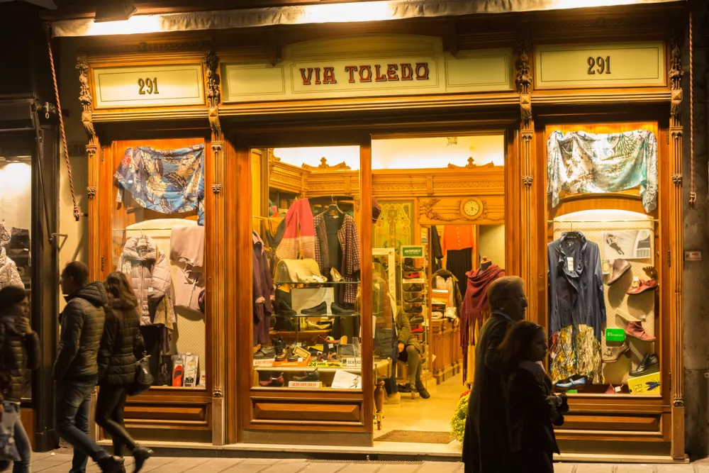NAPLES, ITALY - OCTOBER 31, 2015: Showcase of the clothing store in the historic center of Naples on the Via Toledo street at night.