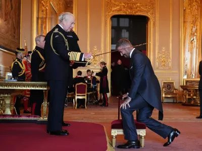 Sir David Beckham is made a Knight Bachelor by Britain's King Charles III during an Investiture ceremony at Windsor Castle, Berkshire, England, Tuesday, Nov. 4, 2025. (Jonathan Brady/PA via AP)