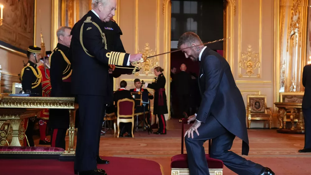 Sir David Beckham is made a Knight Bachelor by Britain's King Charles III during an Investiture ceremony at Windsor Castle, Berkshire, England, Tuesday, Nov. 4, 2025. (Jonathan Brady/PA via AP)