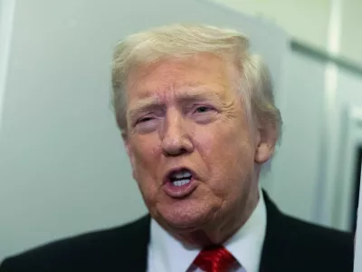 President Donald Trump speaks to reporters on board Air Force One on his way back to the White House from a weekend trip at his Mar-a-Lago estate in Palm Beach, Fla., Sunday, Nov. 2, 2025. (AP Photo/Manuel Balce Ceneta)