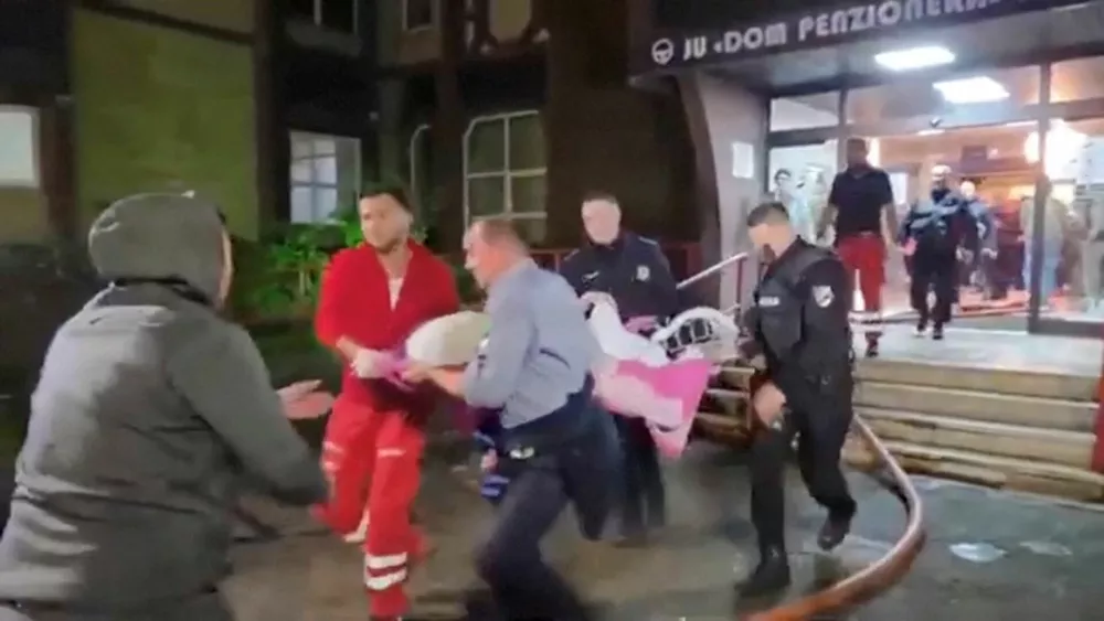 Firefighters carry an injured person on stretcher following a fire in an elderly people's home in Tuzla, Bosnia and Herzegovina, November 4, 2025, in this still image taken from video.  AVAZ via REUTERS TV/Handout via REUTERS  THIS IMAGE HAS BEEN SUPPLIED BY A THIRD PARTY. NO RESALES. NO ARCHIVES. MANDATORY CREDIT. BOSNIA AND HERZEGOVINA OUT. NO COMMERCIAL OR EDITORIAL SALES IN BOSNIA AND HERZEGOVINA