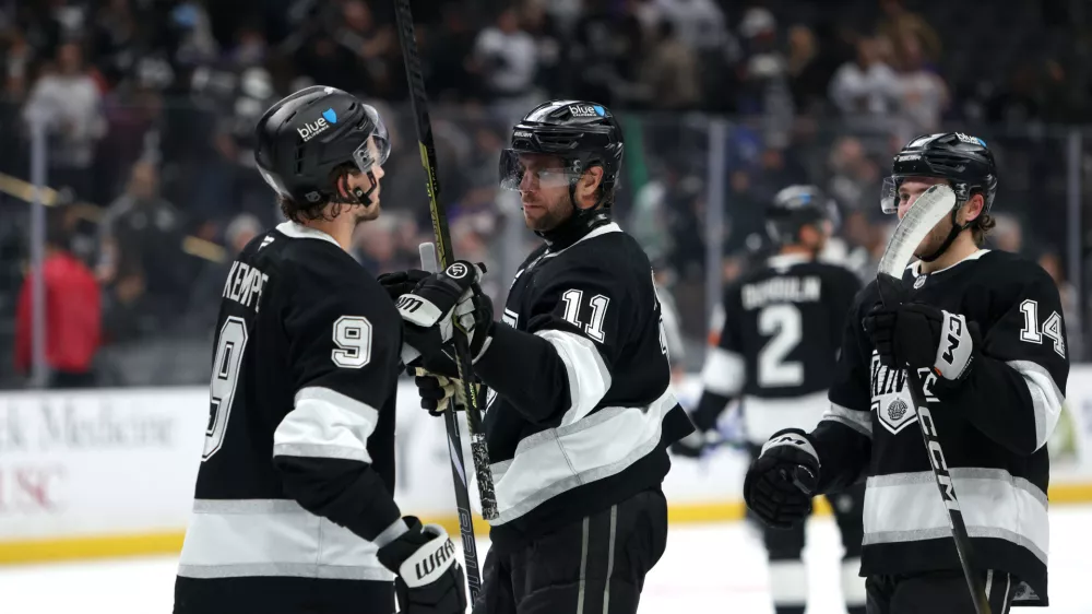 Nov 4, 2025; Los Angeles, California, USA; Los Angeles Kings center Anze Kopitar (11) celebrates a win with right wing Adrian Kempe (9) after defeating the Winnipeg Jets 3-0 at Crypto.com Arena. Mandatory Credit: Kiyoshi Mio-Imagn Images