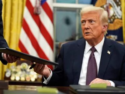 FILE - President Donald Trump signs executive orders in the Oval Office of the White House, Jan. 20, 2025, in Washington. (AP Photo/Evan Vucci, File)