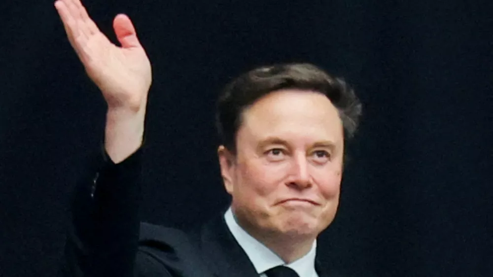 FILE PHOTO: Tesla CEO Elon Musk attends a memorial service for slain conservative commentator Charlie Kirk at State Farm Stadium, in Glendale, Arizona, U.S., September 21, 2025. REUTERS/Daniel Cole/File Photo